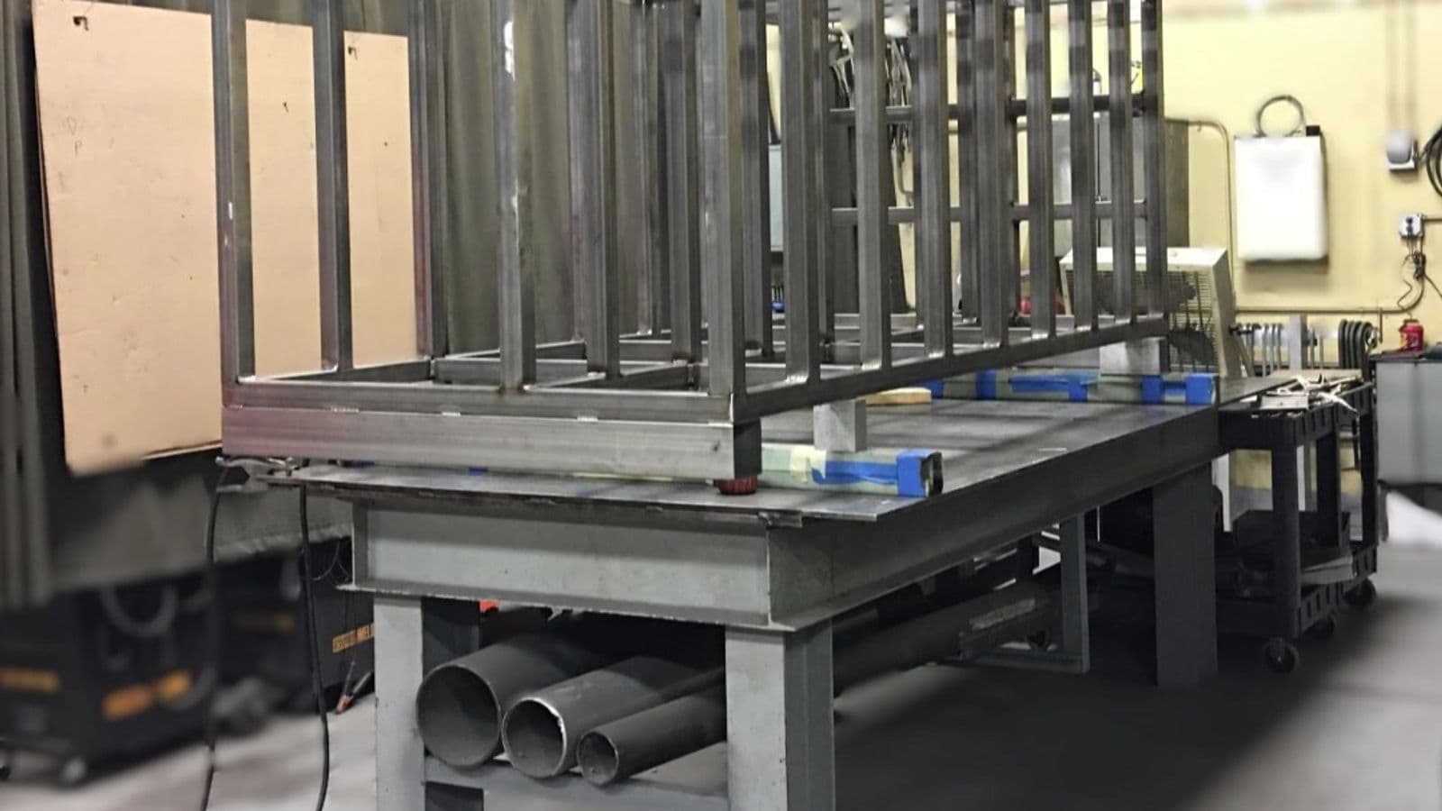 Welded steel rectangular frame structure in progress on a fabrication table in the Hudson Sheet Metal shop